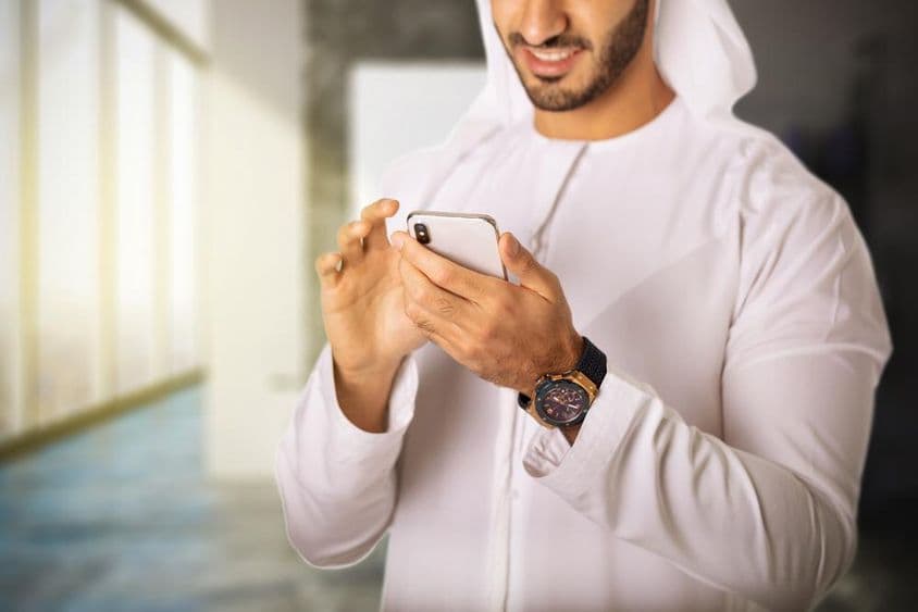 Arab man using a phone.