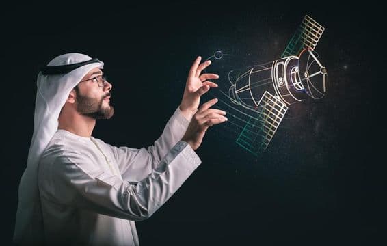 Muslim man in front of projected satellite.
