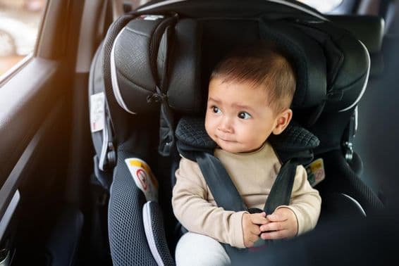 Baby sitting in a car seat.