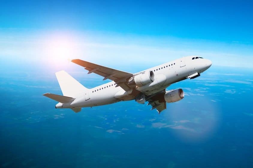 White airplane flying in the sky.