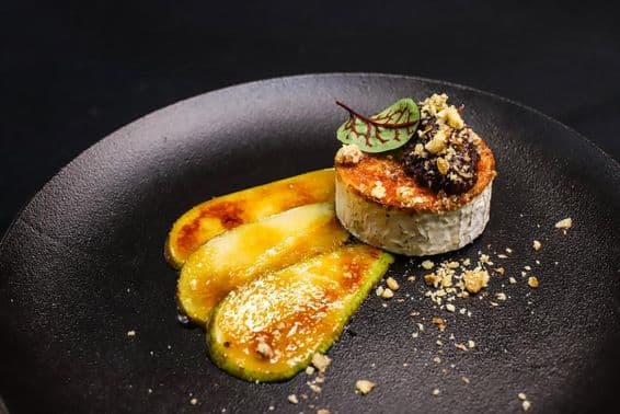 Grilled goat cheese with caramelized pear presented fine dining style