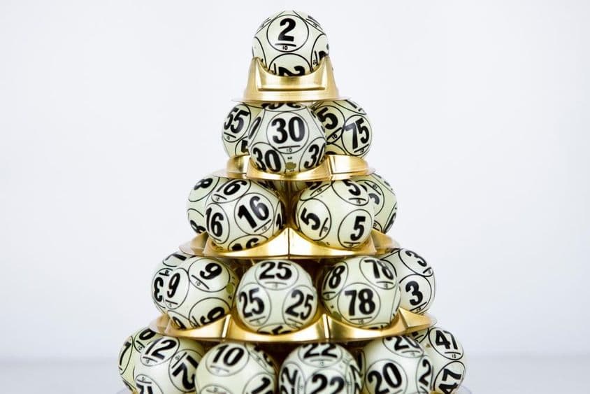 Lotto balls with numbers arranged in a pyramid shape.