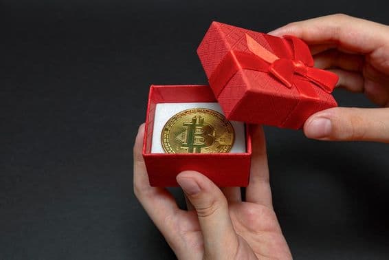 Bitcoin coin in a gift box.