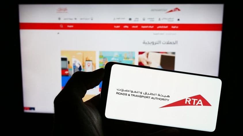 RTA logo on a phone with website background.