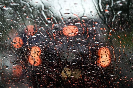 View of Dubai through a wet car window.