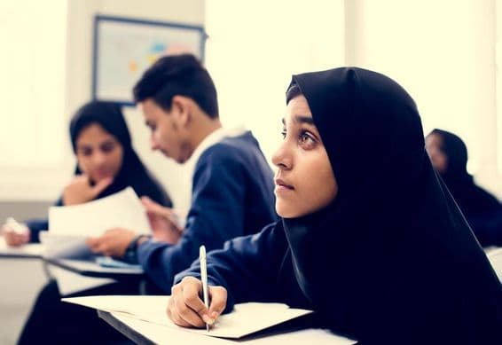 Muslim children studying in a classroom.