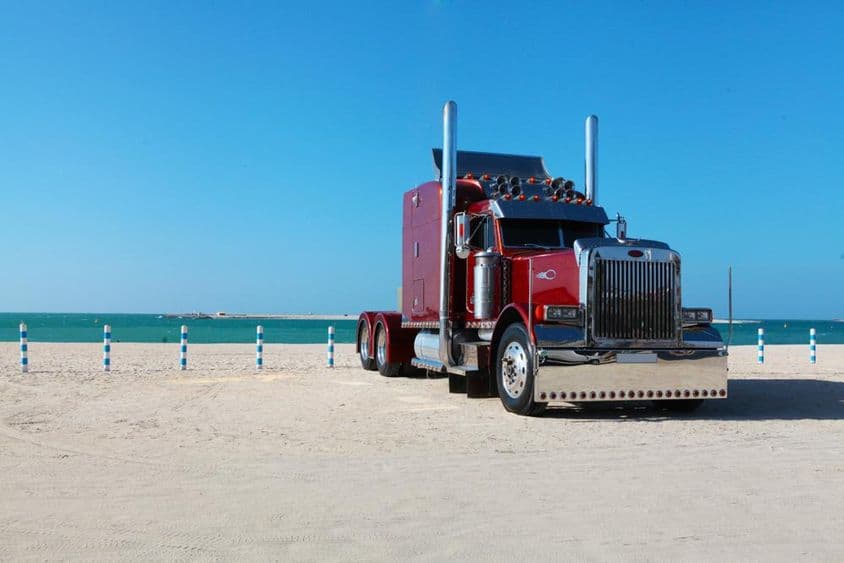Truck parked on Dubai beachfront.