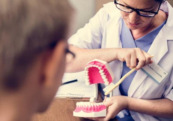 Dubai dentist demonstrating tooth brushing.