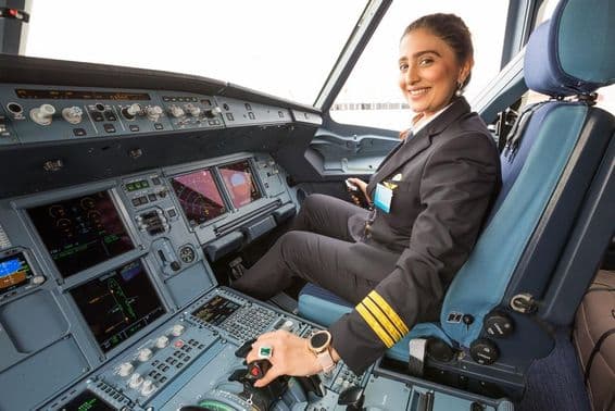 Female pilot in cockpit.