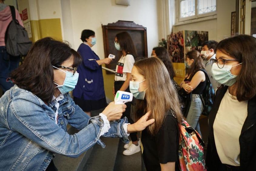 Students have their temperature checked in school.