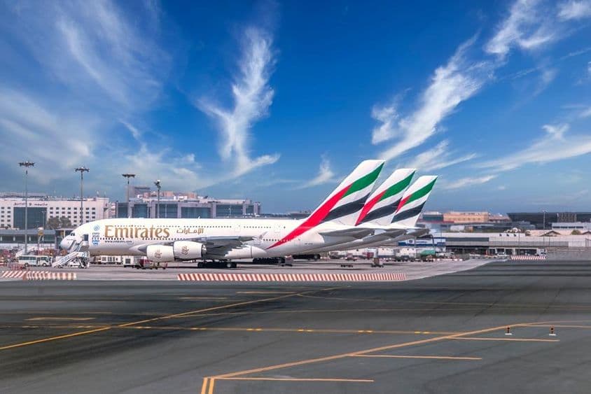 Dubai airport with Emirates planes parked.
