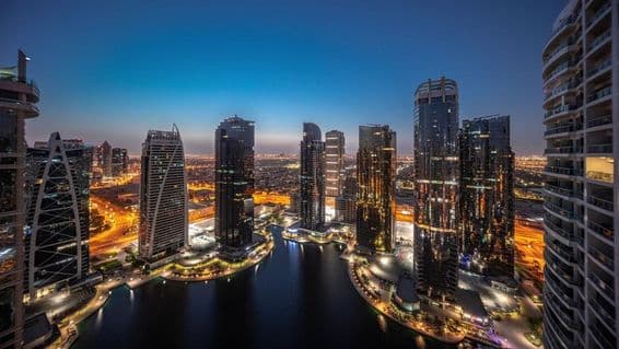Panorama of residential buildings in the JLT area, illuminated towers and skyscrapers.