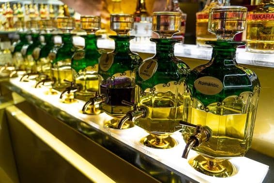 Close-up of essential oil bottles used for perfumery lined up at Souk Madinat Jumeirah marketplace.