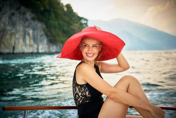 Female model photographed on a wooden motorboat at Lake Como in Italy.