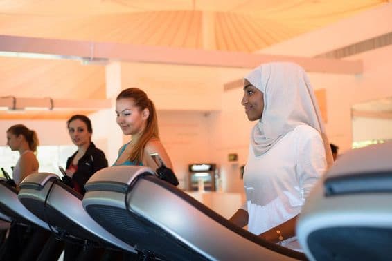 Group of women using the treadmill at the gym.