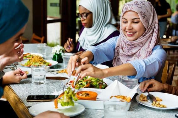 Muslim women dining in hijabs.