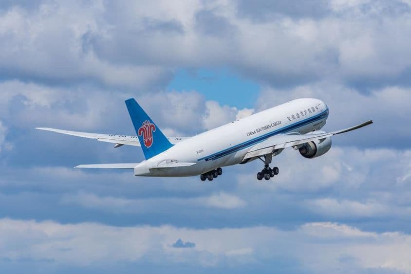 A China Southern Airlines Cargo Boeing 777-F freighter aircraft taking off from the airport.