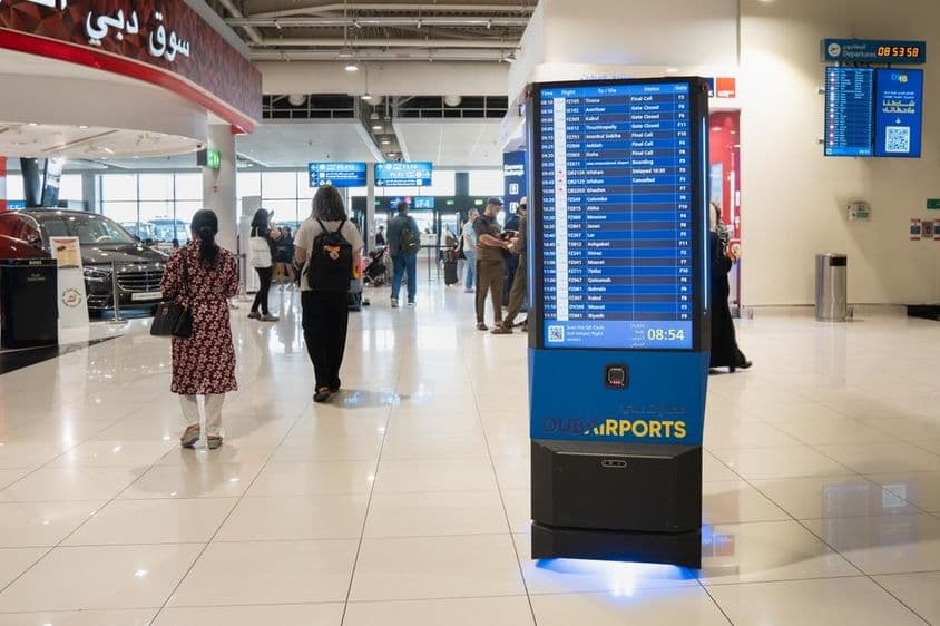 Dubai airport interior with an information board.