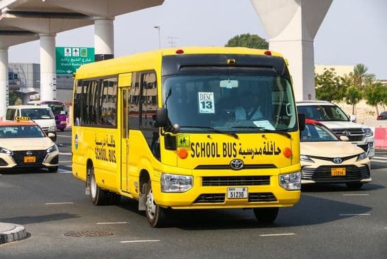School bus Toyota Coaster on a city street.