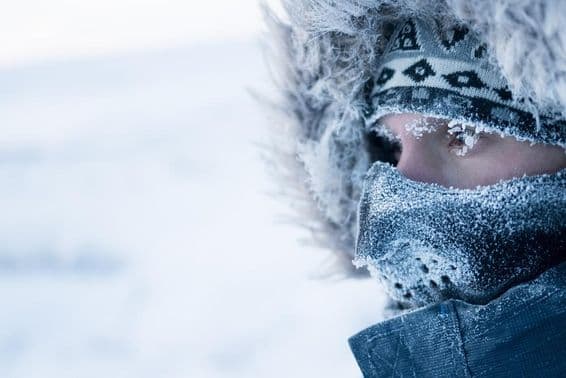 A man in winter clothing and mask, cold arctic climate