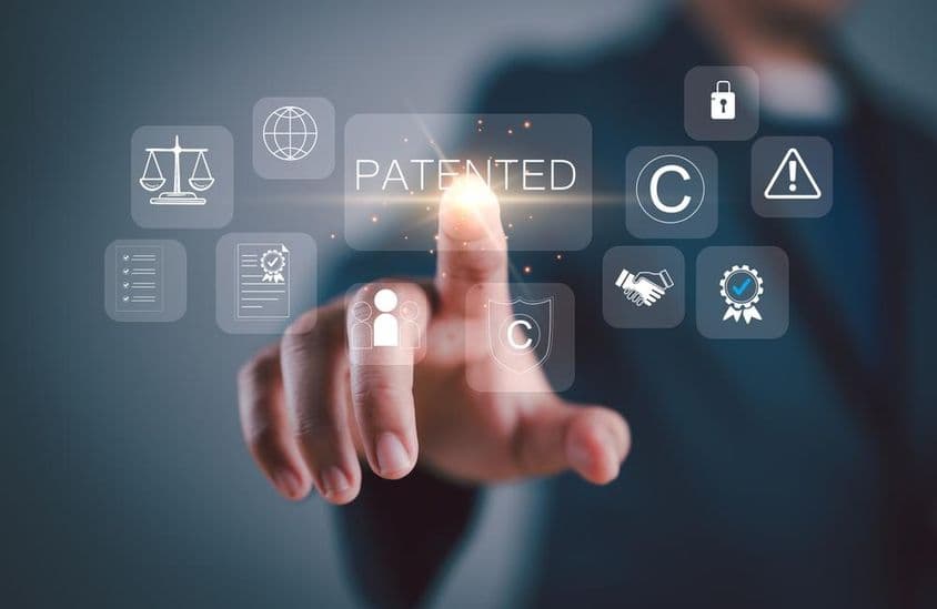 Touchscreen with icons symbolizing copyrights and patented intellectual property.