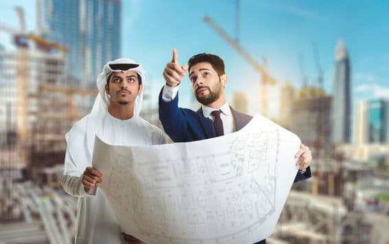 Architect explaining the construction plan to Arab builders