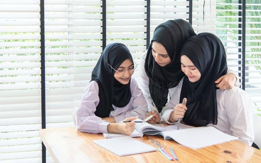 Muslim students studying in a classroom at school.