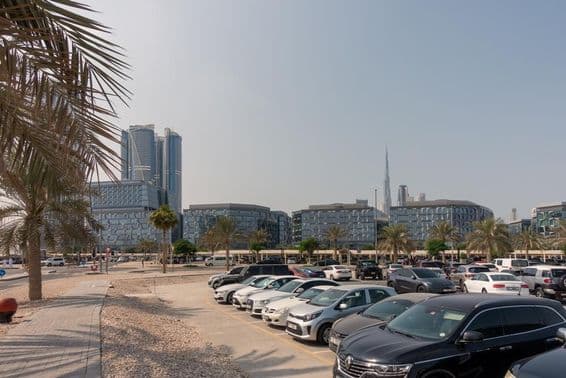 Parking area with a view of Dubai's modern office buildings.