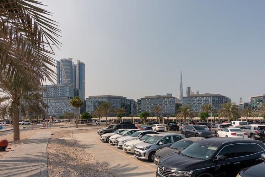 Parking area with a view of Dubai's modern office buildings.