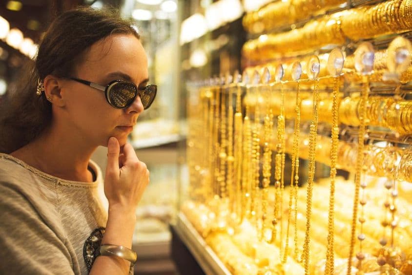 A young girl looking at gold jewelry in the Dubai gold market.