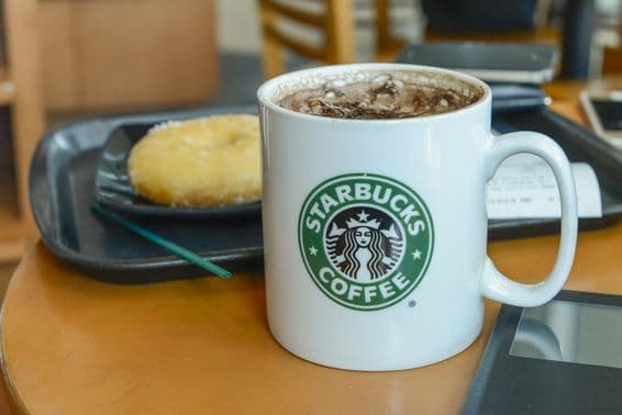 Cocoa cappuccino in a hot, steaming mug in a Starbucks cafe.