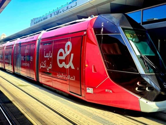 A red tram with Etisalat advertisements.