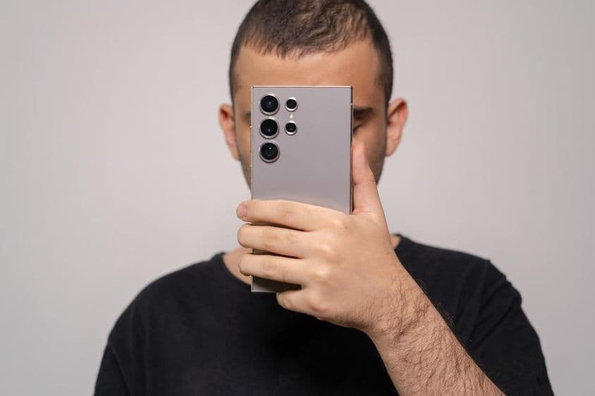 Man holding Samsung S24 Ultra smartphone, highlighting the elegant design.