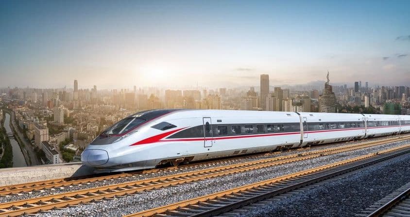 Futuristic high-speed train gliding on tracks.