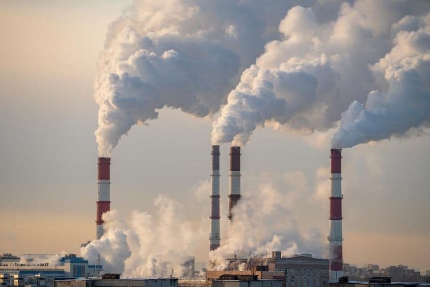 Factory chimneys emitting smoke.