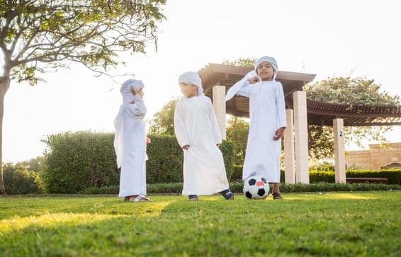 A group of Middle Eastern children playing and having fun outdoors.