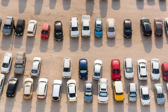 Sharjah, UAE, aerial view of parked cars on sand.