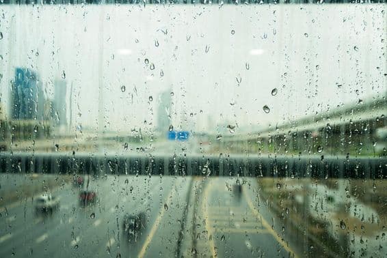 Raindrops on a glass window after heavy rainfall in Dubai.