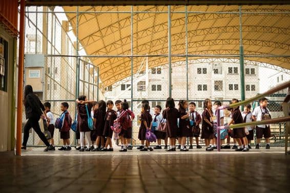 Children walking on a school campus.