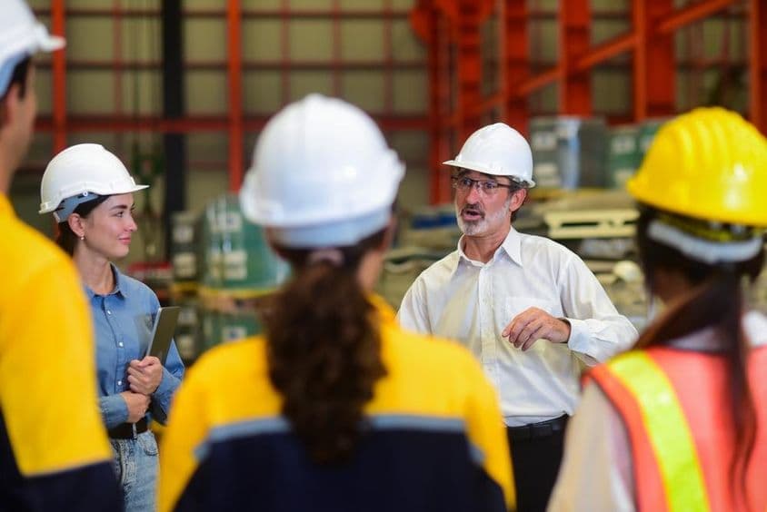 Manager engineer briefing the workers.