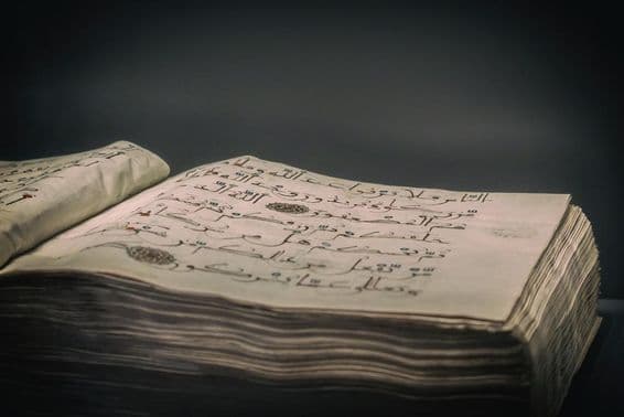 Ancient open book manuscript, 12th-13th century.