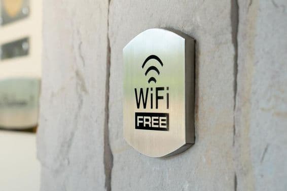 Metal WIFI sign on a hotel wall.