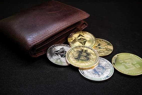 Wallet with various cryptocurrencies like Bitcoin and Ethereum on a black background.