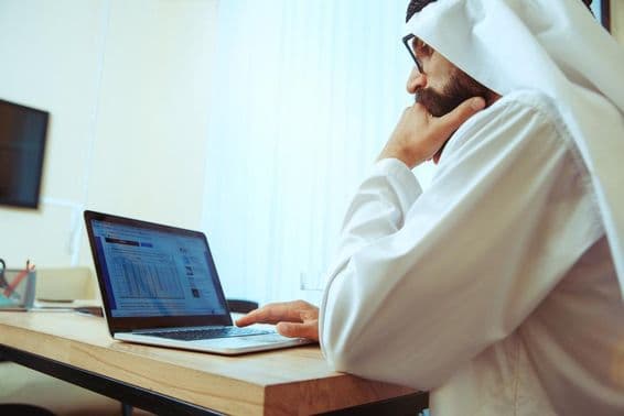 Arab businessman working online in a comfortable office.