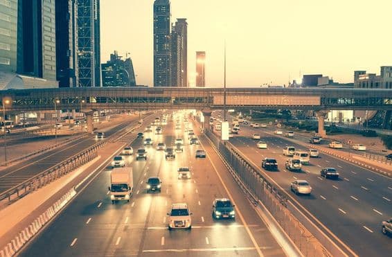 Skyscrapers, roads, and bridge on Sheikh Zayed Road in Dubai at night.