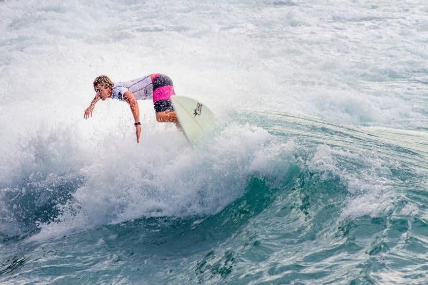 Young guy surfing a big wave.