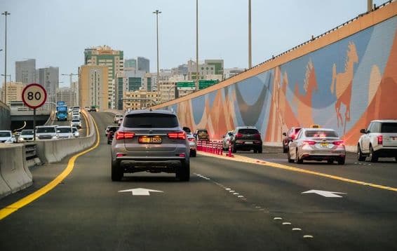 Car traffic on a highway with skyscrapers in the background in Dubai, United Arab Emirates.