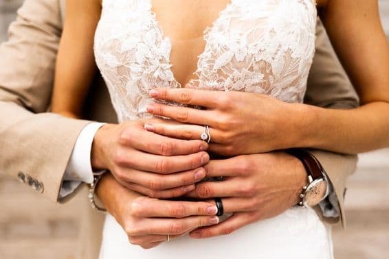 Young couple, wearing rings.