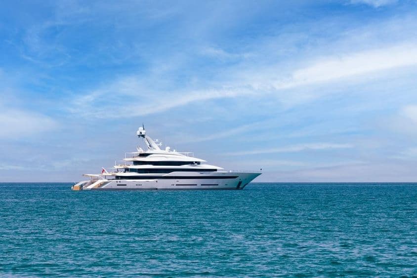 Private luxury superyacht anchored on the water.