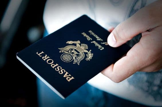 Man holding a blue passport.